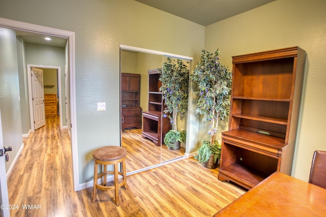 interior space featuring light wood finished floors and baseboards