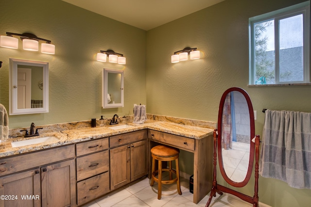 bathroom featuring double vanity, tile patterned flooring, and a sink