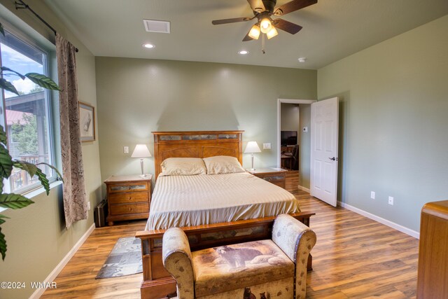 bedroom with recessed lighting, visible vents, light wood-style flooring, a ceiling fan, and baseboards