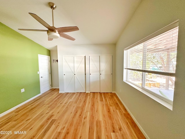 2872 Mustang Trl, Overgaard, AZ 85933 - unfurnished bedroom with vaulted ceiling, two closets, light wood-style flooring, and a ceiling fan
