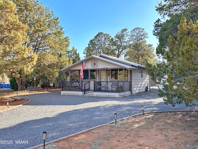 2872 Mustang Trl, Overgaard, AZ 85933 - view of front of house with a porch and driveway