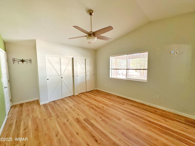 2872 Mustang Trl, Overgaard, AZ 85933 - unfurnished bedroom featuring light wood finished floors, vaulted ceiling, two closets, and a ceiling fan