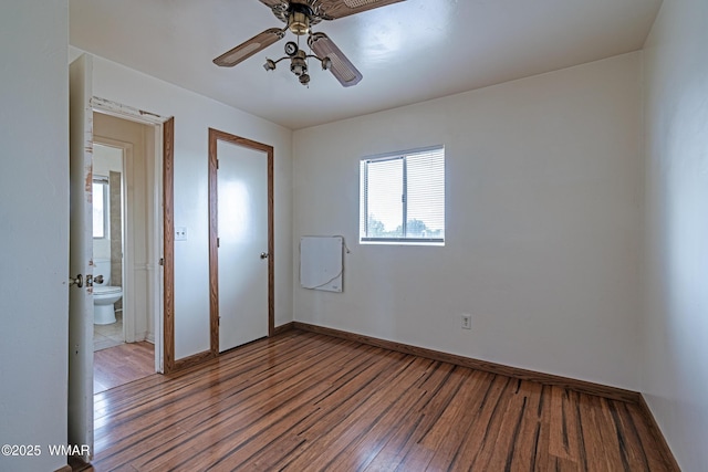 8460 Powells Ln, Show Low, AZ 85901 - unfurnished bedroom with wood finished floors, baseboards, and a ceiling fan