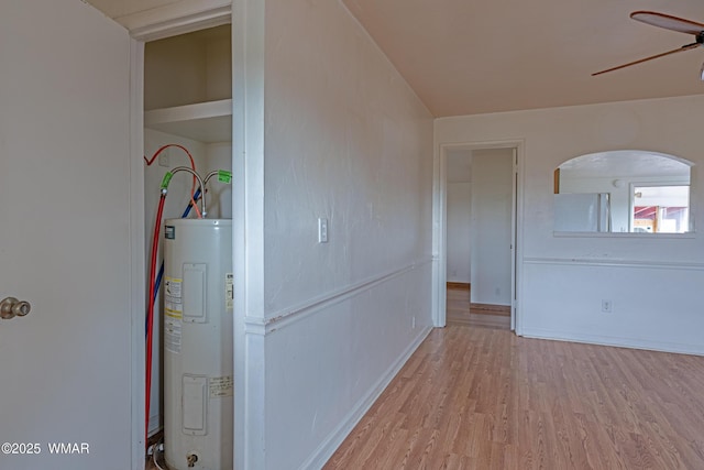 8460 Powells Ln, Show Low, AZ 85901 - corridor with water heater, wood finished floors, and baseboards