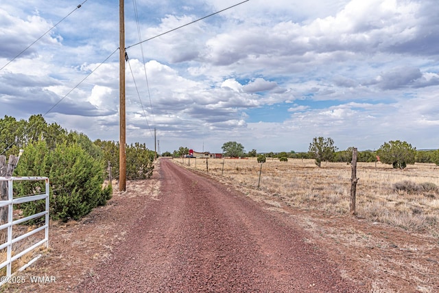 8460 Powells Ln, Show Low, AZ 85901 - view of dirt / gravel road featuring a view of countryside and a gated entry