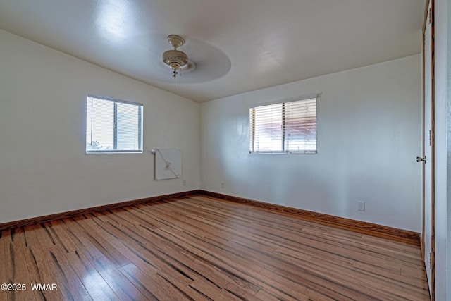 8460 Powells Ln, Show Low, AZ 85901 - unfurnished room with wood finished floors, a ceiling fan, healthy amount of natural light, and baseboards