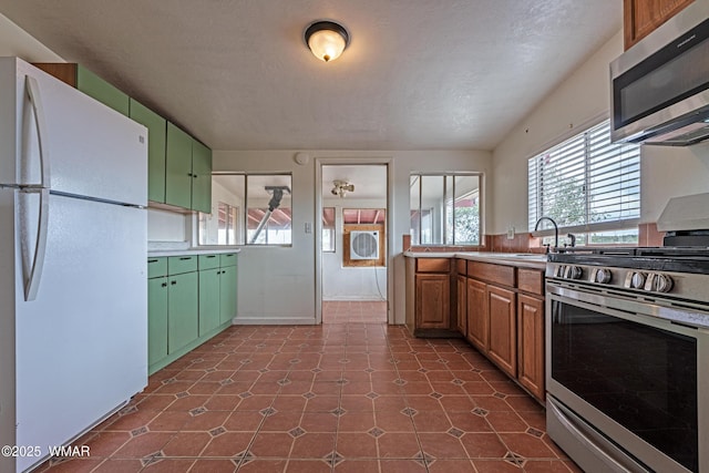 8460 Powells Ln, Show Low, AZ 85901 - kitchen with appliances with stainless steel finishes, plenty of natural light, green cabinetry, and a sink