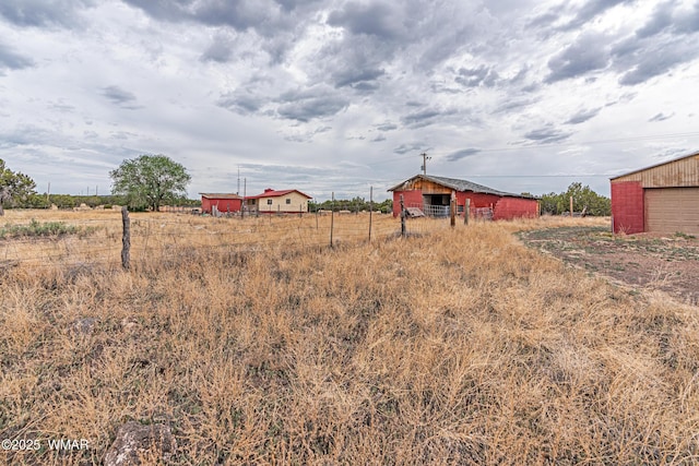 8460 Powells Ln, Show Low, AZ 85901 - view of yard with an outdoor structure, a view of countryside, a pole building, and a garage