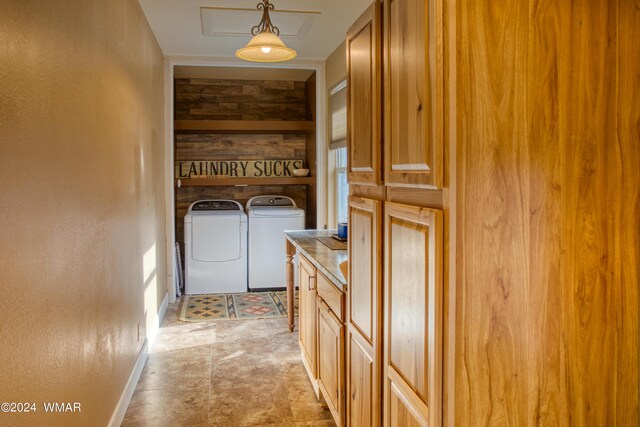 washroom with washer and dryer, laundry area, a textured wall, and baseboards