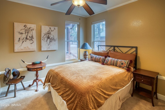 bedroom with baseboards, ceiling fan, light colored carpet, and crown molding