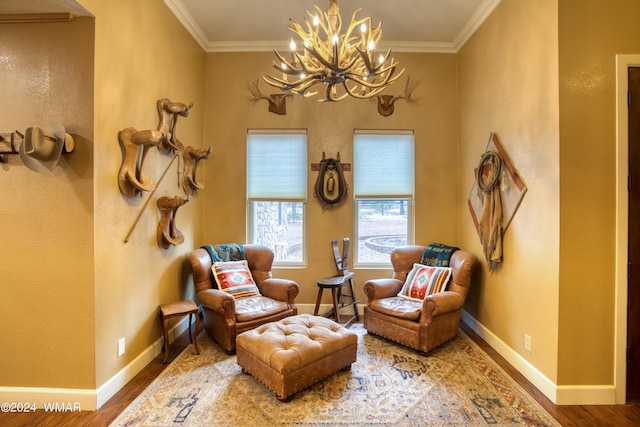 living area featuring baseboards, ornamental molding, and wood finished floors