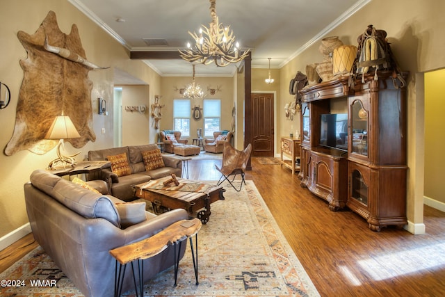 living room featuring wood finished floors, visible vents, baseboards, an inviting chandelier, and crown molding