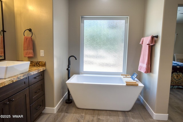 3511 W Falling Leaf Rd, Show Low, AZ 85901 - full bathroom featuring a freestanding bath, vanity, wood finished floors, and plenty of natural light