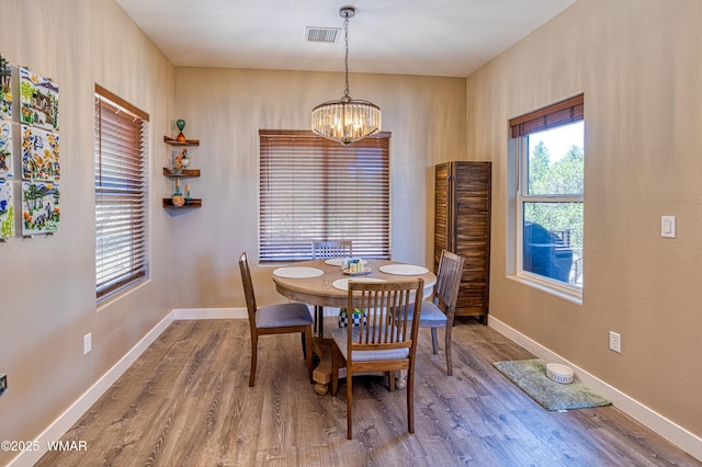 3511 W Falling Leaf Rd, Show Low, AZ 85901 - dining space with wood finished floors and a chandelier