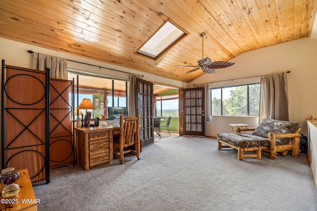 carpeted office featuring ceiling fan, lofted ceiling with skylight, and wood ceiling