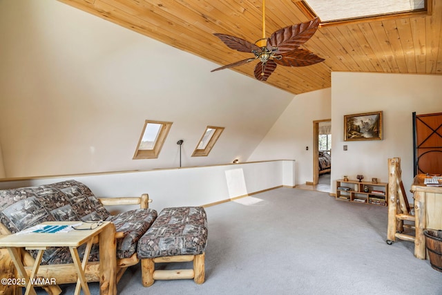 living area with baseboards, carpet flooring, lofted ceiling with skylight, ceiling fan, and wood ceiling