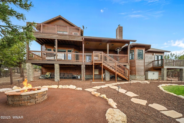 1610 S Canyon Ridge Trl, Show Low, AZ 85901 - back of property with a fire pit, stairway, a chimney, a deck, and a patio area