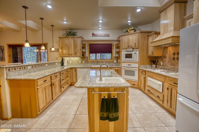 kitchen with a sink, a warming drawer, custom exhaust hood, white appliances, and open shelves