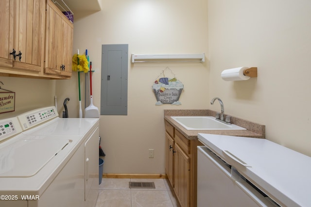 clothes washing area with visible vents, a sink, electric panel, separate washer and dryer, and cabinet space