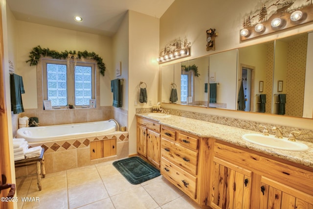 full bathroom featuring tile patterned floors, a sink, and a wealth of natural light