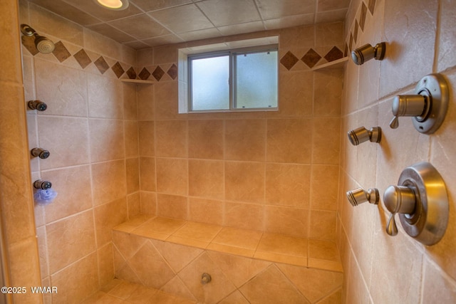 full bath with a tile shower