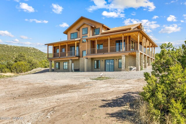436 E 11th Ln, Eagar, AZ 85925 - rear view of house featuring log siding, a balcony, and dirt driveway