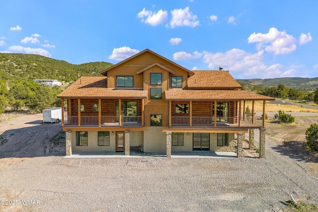 436 E 11th Ln, Eagar, AZ 85925 - back of house featuring a shingled roof, a mountain view, a balcony, and log exterior