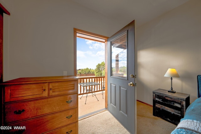 bedroom with baseboards and light carpet