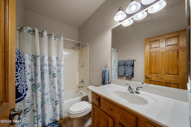 bathroom featuring vanity, toilet, and shower / bath combo with shower curtain