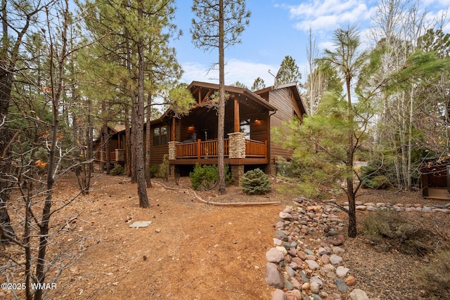 rear view of house with a wooden deck