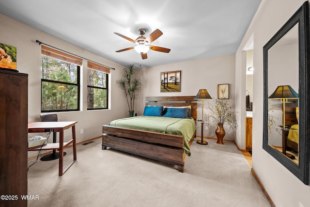 bedroom with light carpet, a ceiling fan, visible vents, and baseboards