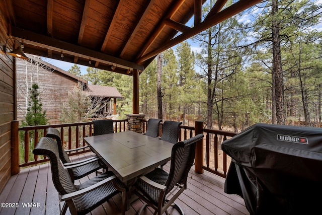 wooden deck with grilling area and outdoor dining area