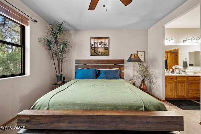 bedroom featuring ceiling fan and ensuite bathroom