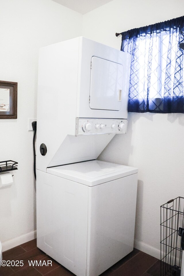 2853 Markham Rd, Overgaard, AZ 85933 - washroom with stacked washer / dryer, baseboards, and dark wood-type flooring
