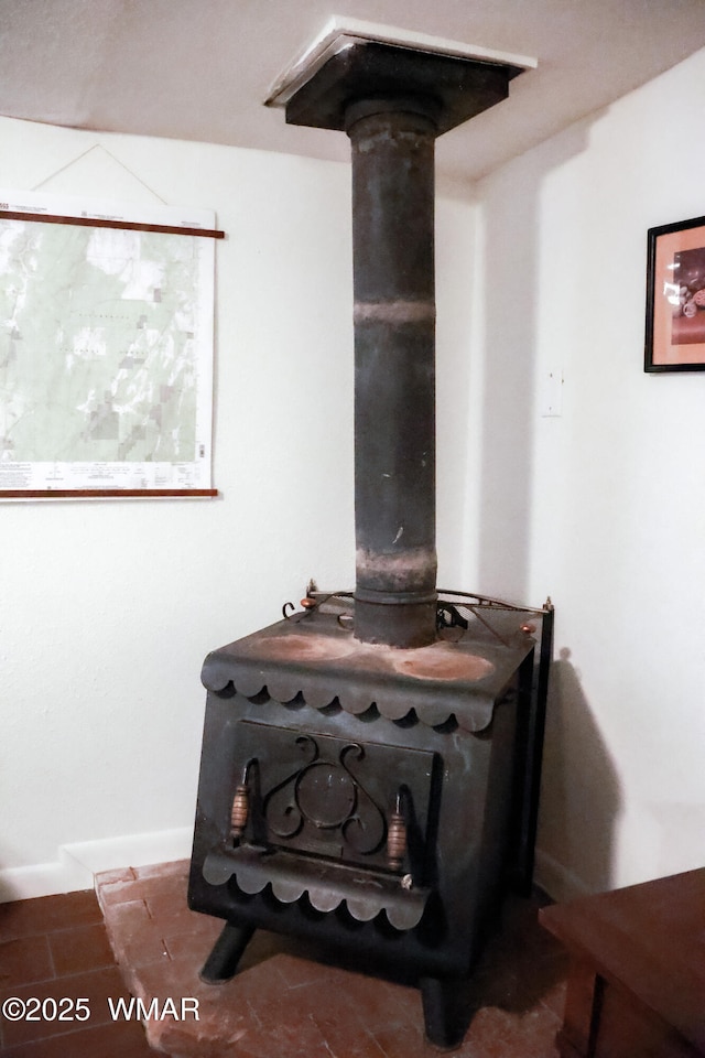 2853 Markham Rd, Overgaard, AZ 85933 - detailed view of a wood stove and baseboards