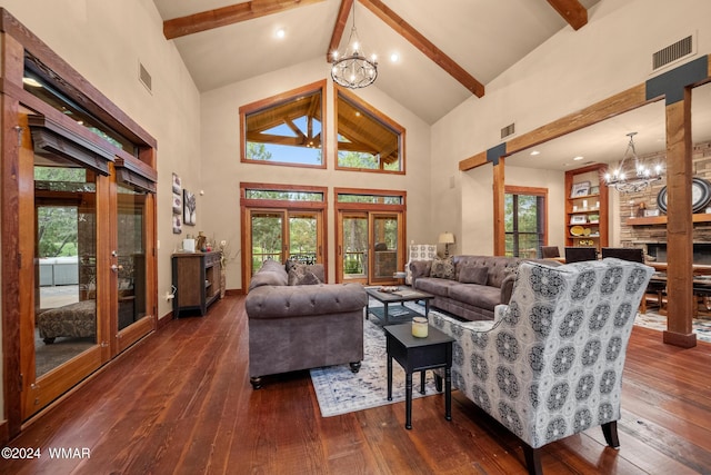 living room featuring a chandelier, beamed ceiling, dark wood finished floors, and visible vents