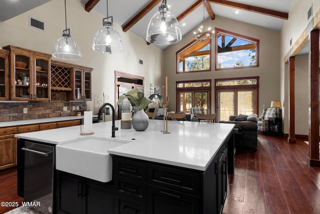 kitchen with dark wood-style flooring, a sink, visible vents, open floor plan, and light countertops