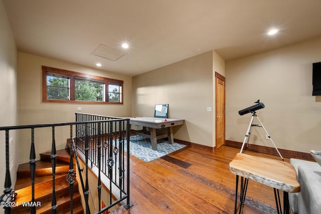 hallway featuring recessed lighting, visible vents, an upstairs landing, wood finished floors, and baseboards