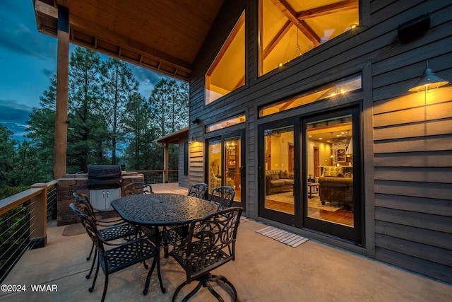 view of patio featuring outdoor dining area, area for grilling, and french doors