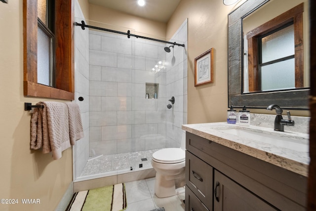 bathroom featuring vanity, a shower stall, toilet, and tile patterned floors