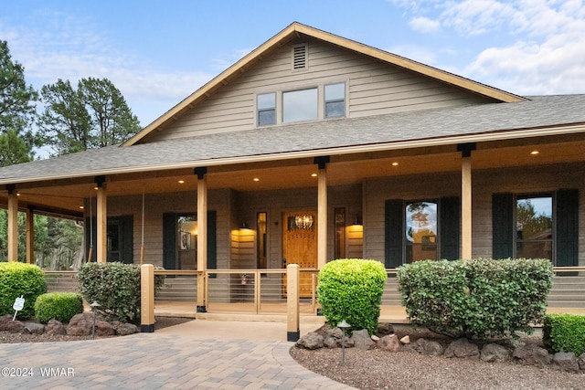 view of front of house featuring a porch and roof with shingles