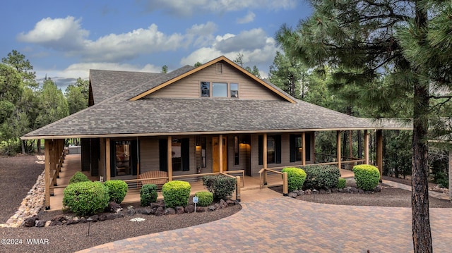 view of front of property featuring a porch and a shingled roof