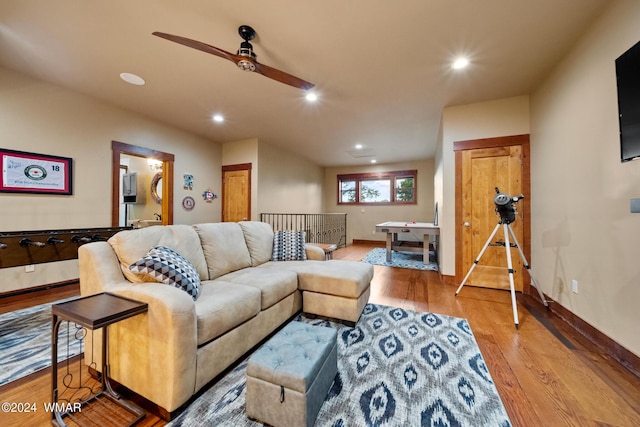 living room featuring a ceiling fan, baseboards, wood finished floors, and recessed lighting