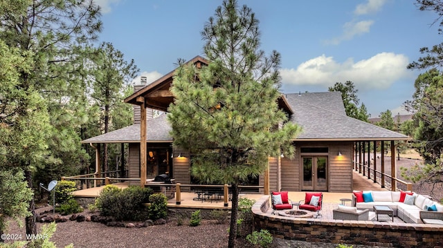 back of property with french doors, a chimney, an outdoor hangout area, roof with shingles, and a wooden deck