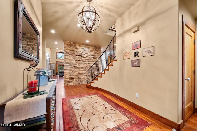 entryway with baseboards, stairway, wood finished floors, a notable chandelier, and recessed lighting