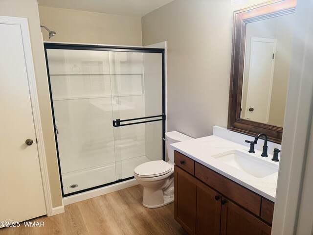 7287 Moon Creek Cir, Pinetop, AZ 85935 - full bathroom featuring wood finished floors, a shower stall, and toilet