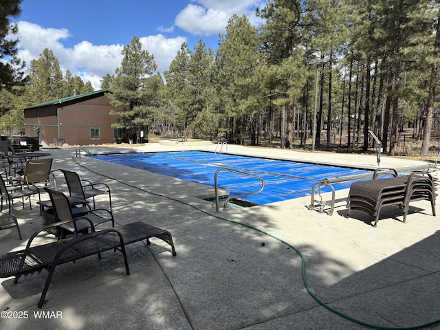 community pool featuring a patio area