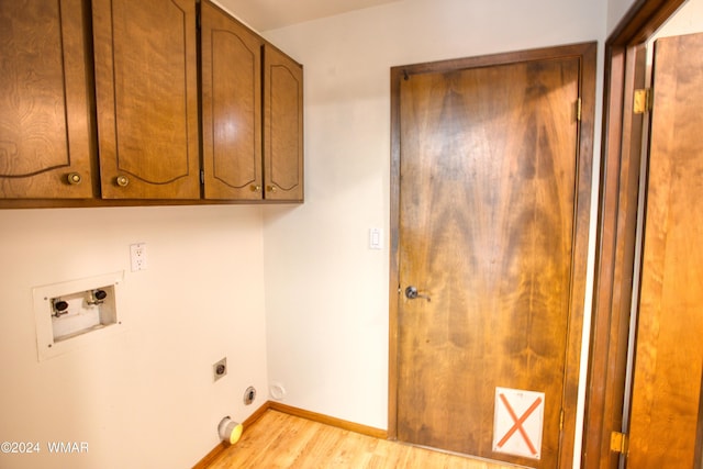 laundry room featuring washer hookup, cabinet space, light wood-style floors, hookup for an electric dryer, and baseboards