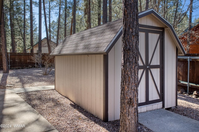 view of shed with fence