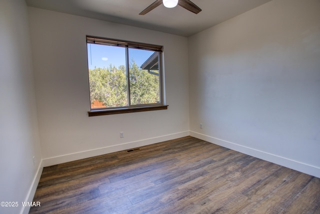 2071 N Bison Pass Ct, Show Low, AZ 85901 - spare room with a ceiling fan, dark wood-style flooring, and baseboards